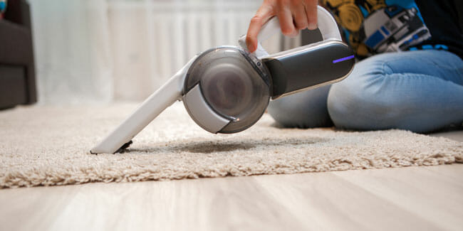 Cleaning of rug in house portable vacuum cleaner